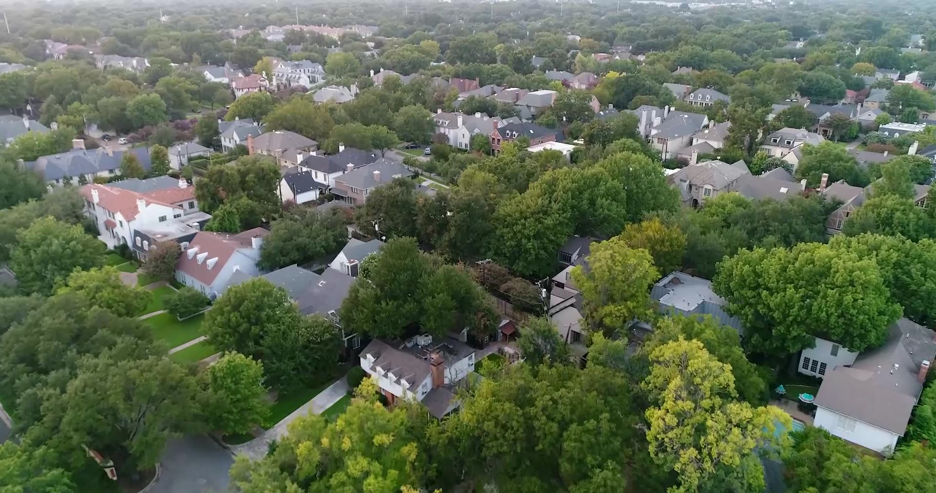 Aerial view of tree lined Highland Park streets and homes in Dallas