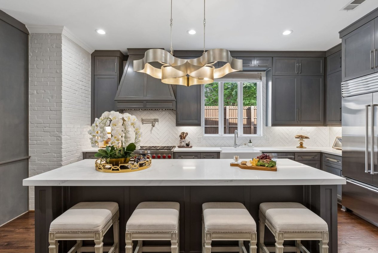 Kitchen with a marble island in a Dallas area home represented by Grecia Garza-Castillo